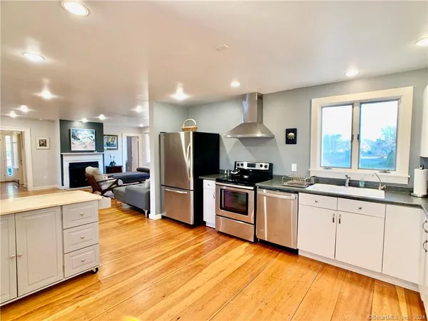 a kitchen with stainless steel appliances granite countertop a sink and cabinets