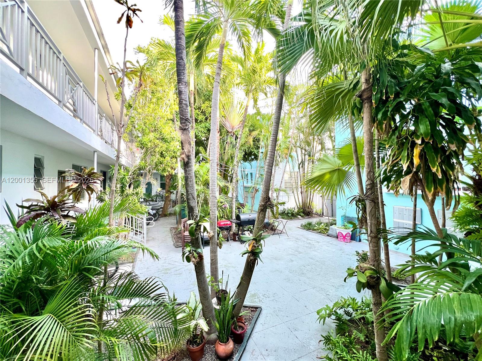 135 3rd Street, Unit 25 Miami Beach, FL 33139 - Photo 2 of 12 a view of a garden with tall trees
