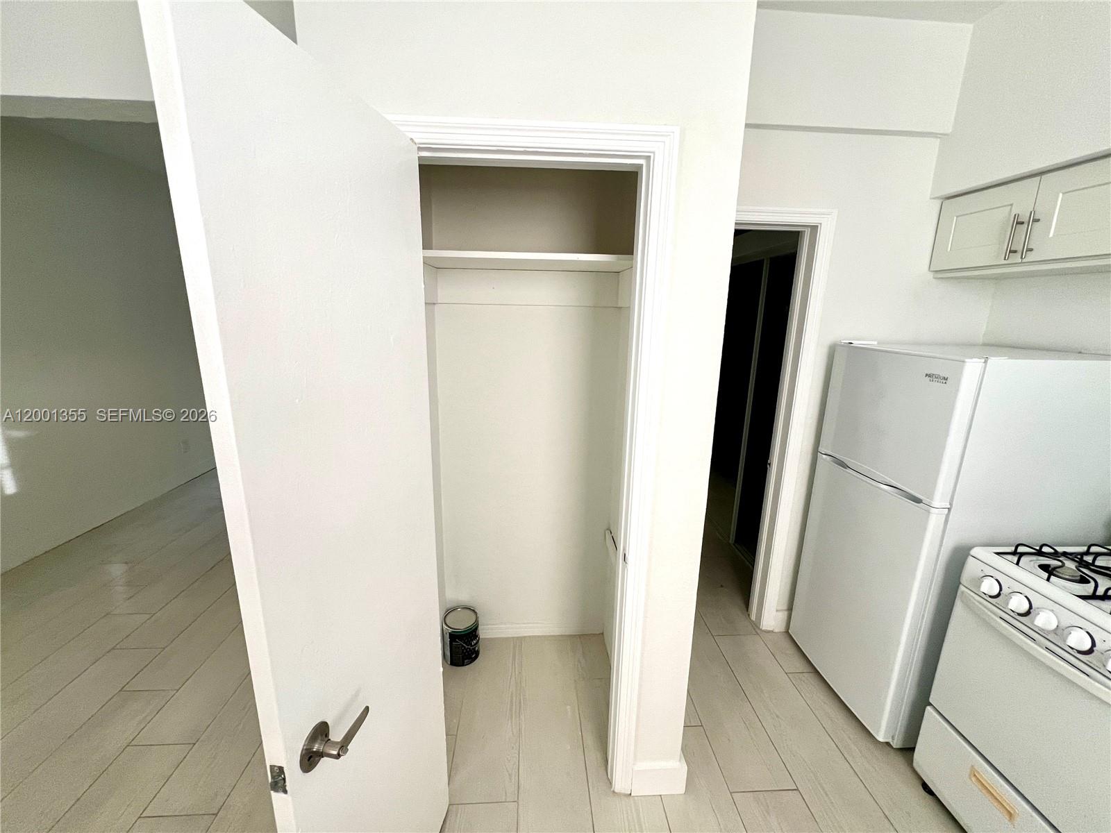 135 3rd Street, Unit 25 Miami Beach, FL 33139 - Photo 8 of 12 a view of a storage and utility room with refrigerator