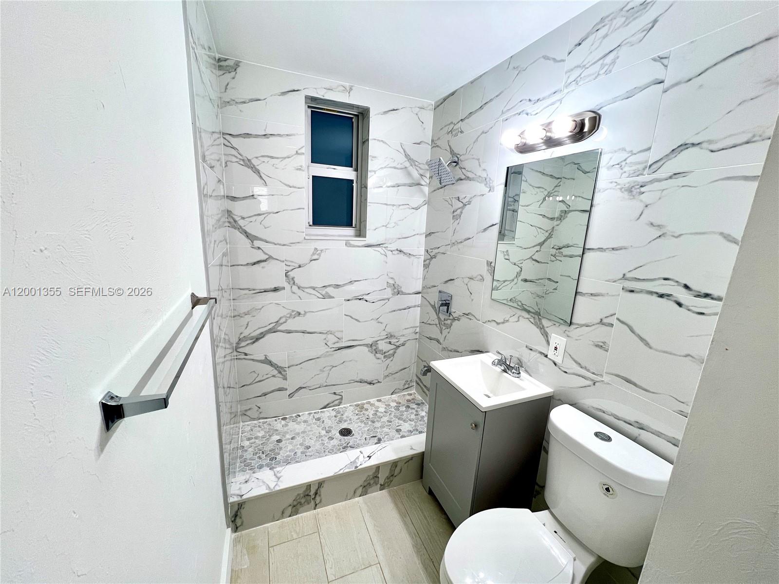 135 3rd Street, Unit 25 Miami Beach, FL 33139 - Photo 9 of 12 a white toilet sitting next to a bathroom sink