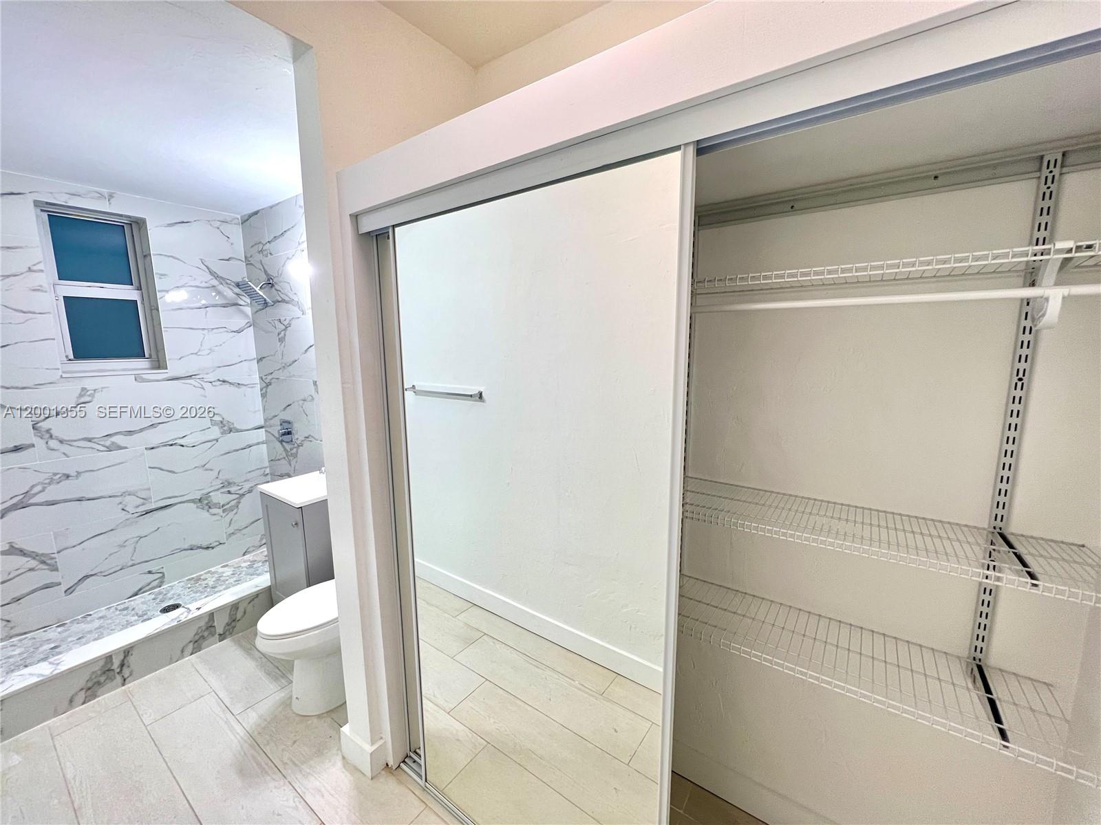 135 3rd Street, Unit 25 Miami Beach, FL 33139 - Photo 10 of 12 a bathroom with a shower and a toilet
