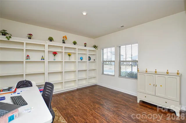 a living room with hard wood floor and a window