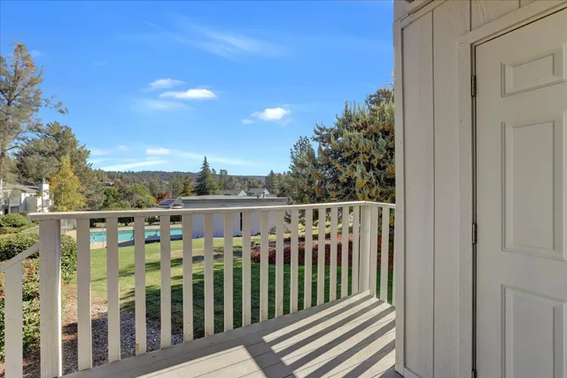 a view of a balcony with wooden fence