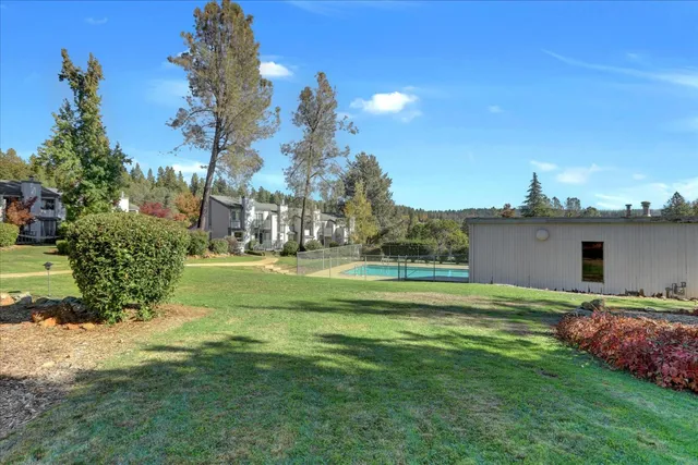a view of a house with a big yard and potted plants