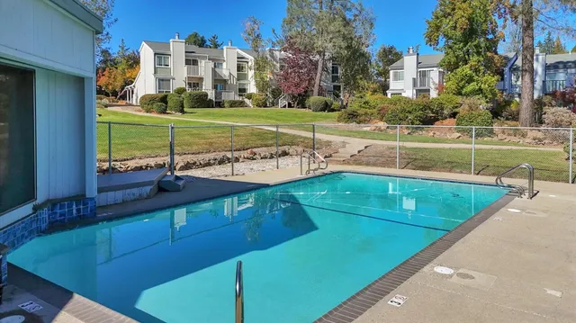 a backyard of a house with table and chairs