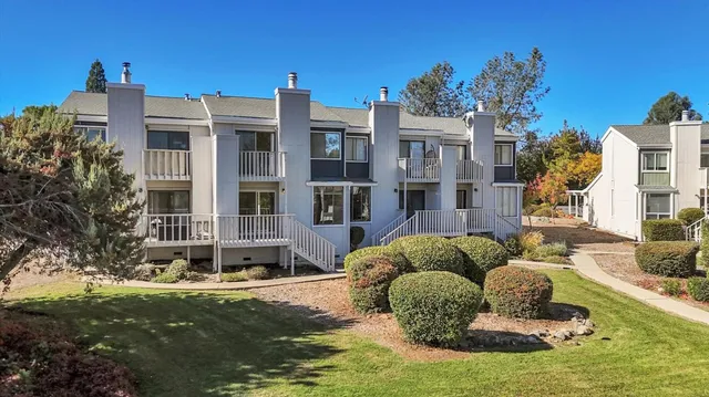 a kitchen with granite countertop a sink stove and cabinets