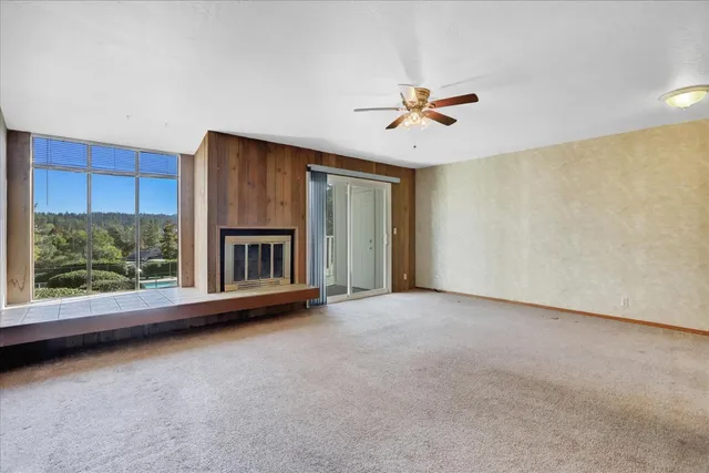 a view of a livingroom with a ceiling fan and window