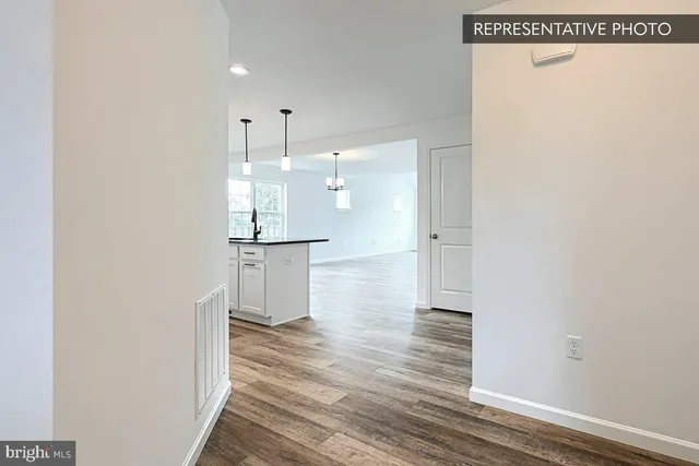 a view of a kitchen with wooden floor and a sink