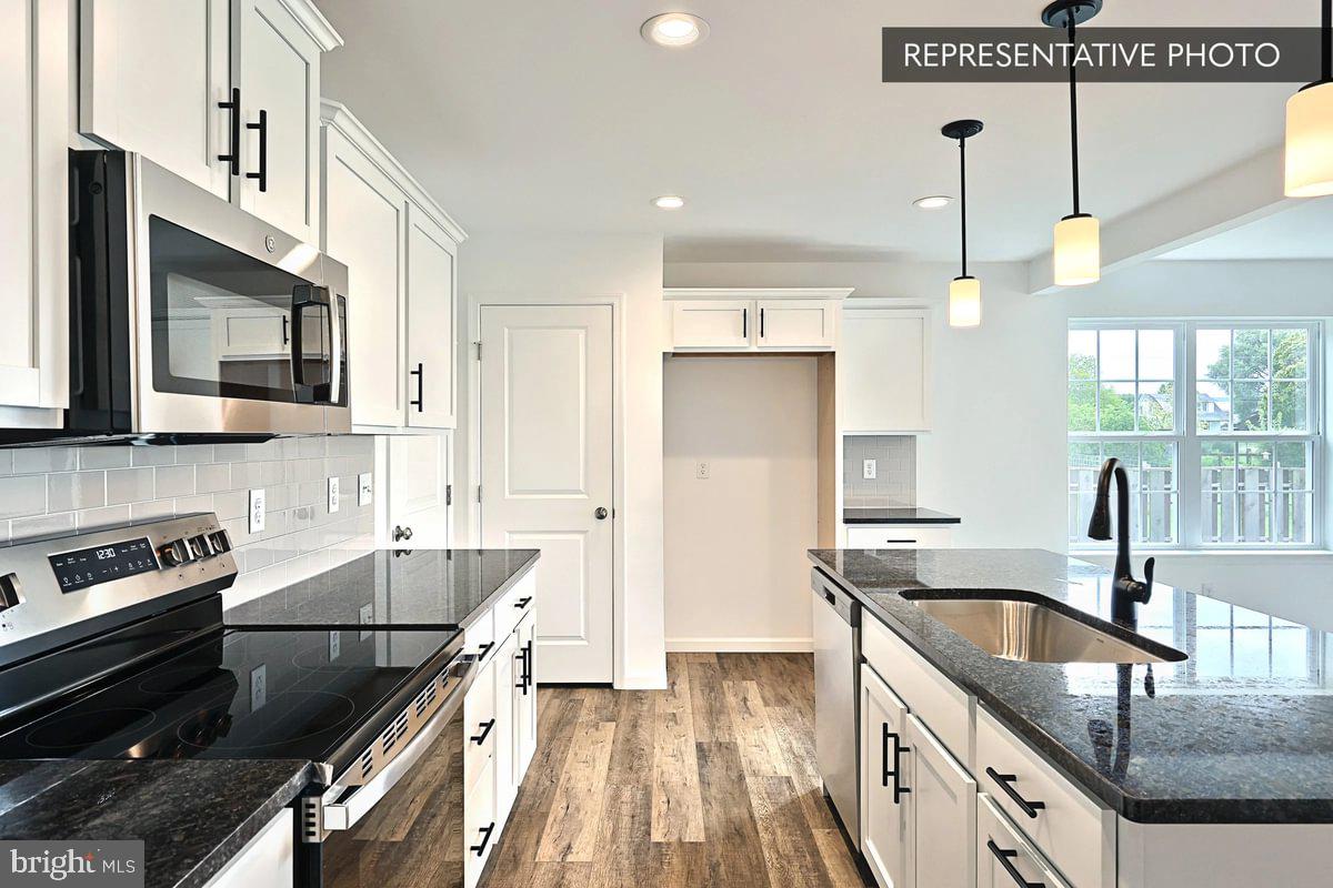 243 Abercorn Street State College, PA 16803 - Photo 10 of 21 a kitchen with granite countertop a sink a counter space appliances and cabinets