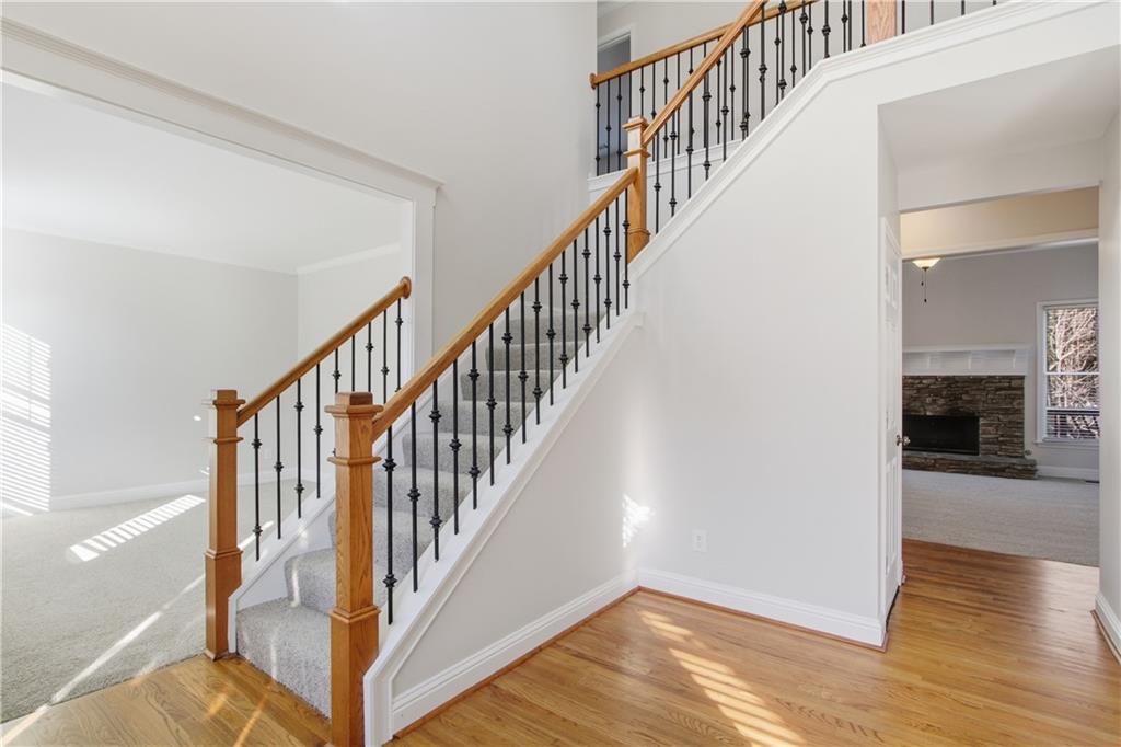 511 Highwater Pass Canton, GA 30114 - Photo 2 of 39 a view of staircase with wooden floor and stairs
