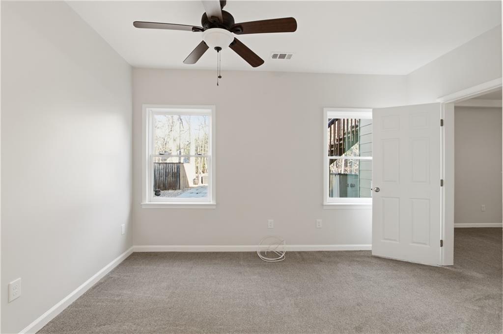 511 Highwater Pass Canton, GA 30114 - Photo 22 of 39 an empty room with windows and fan