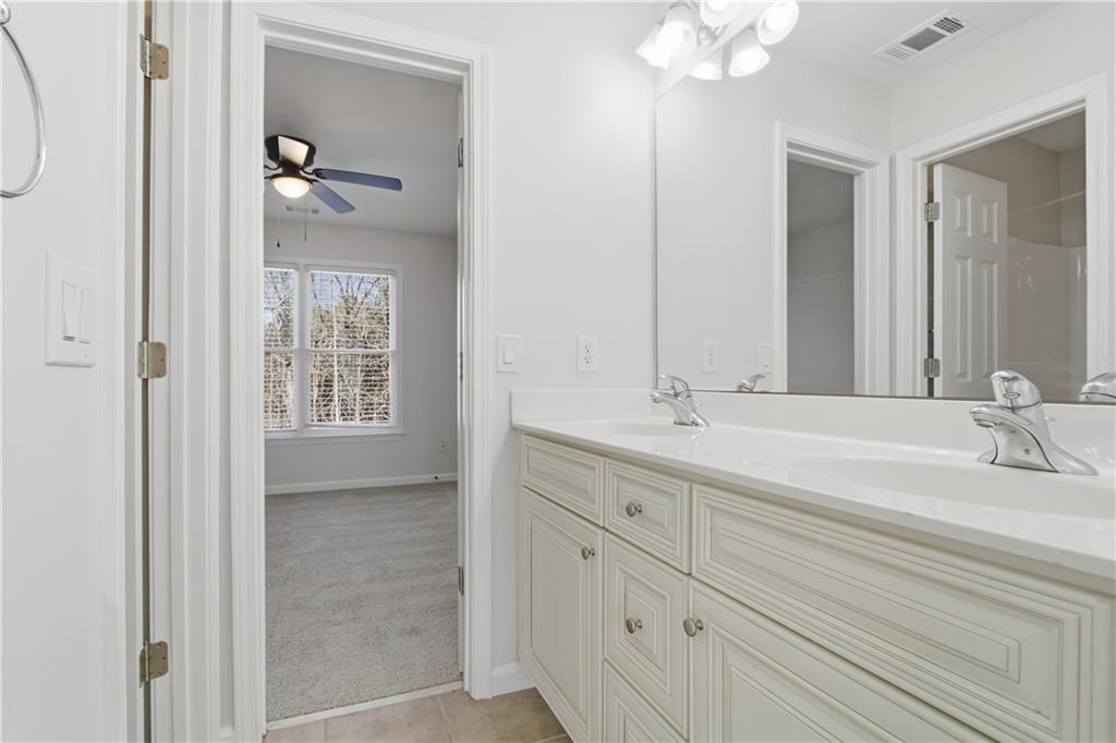 511 Highwater Pass Canton, GA 30114 - Photo 28 of 39 a bathroom with a double vanity sink and mirror with window