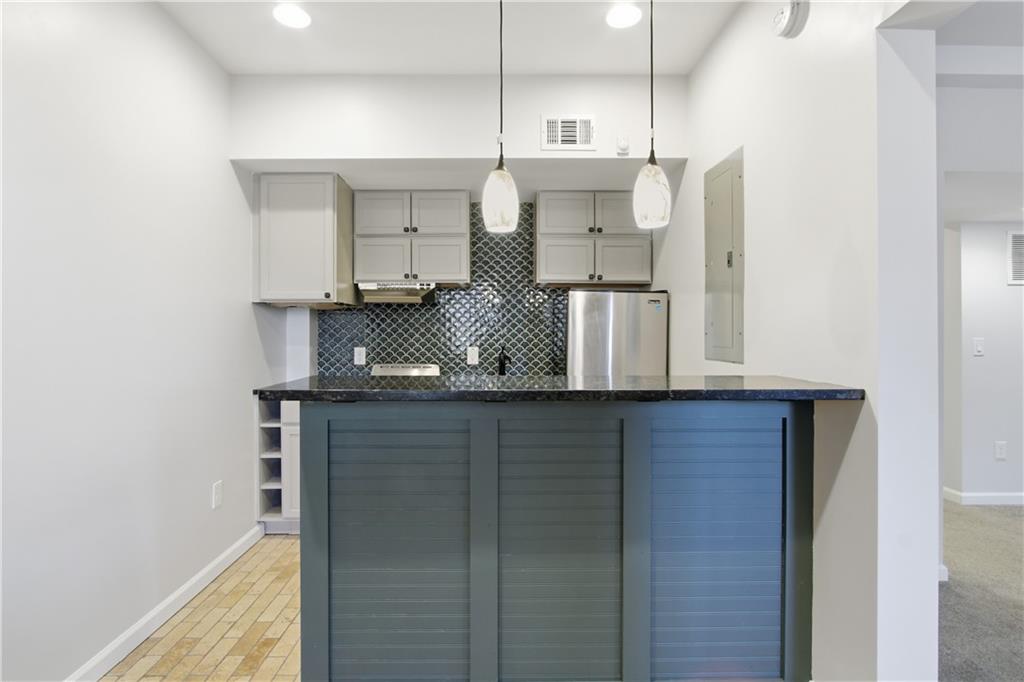 511 Highwater Pass Canton, GA 30114 - Photo 32 of 39 a kitchen with stainless steel appliances granite countertop a sink and a refrigerator