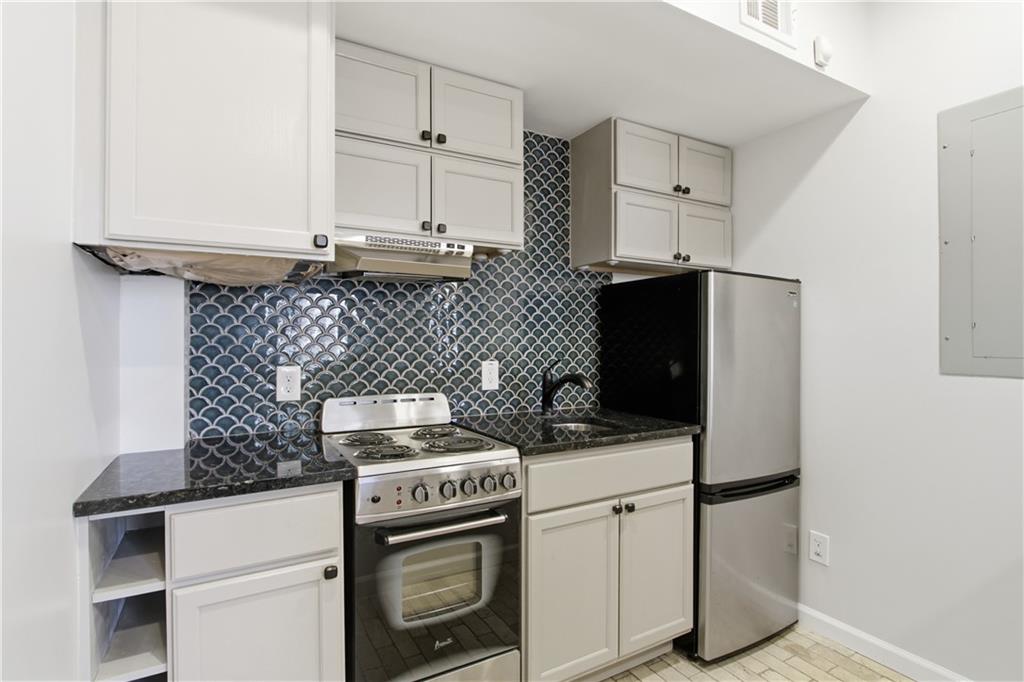 511 Highwater Pass Canton, GA 30114 - Photo 33 of 39 a kitchen with appliances cabinets and a counter top space
