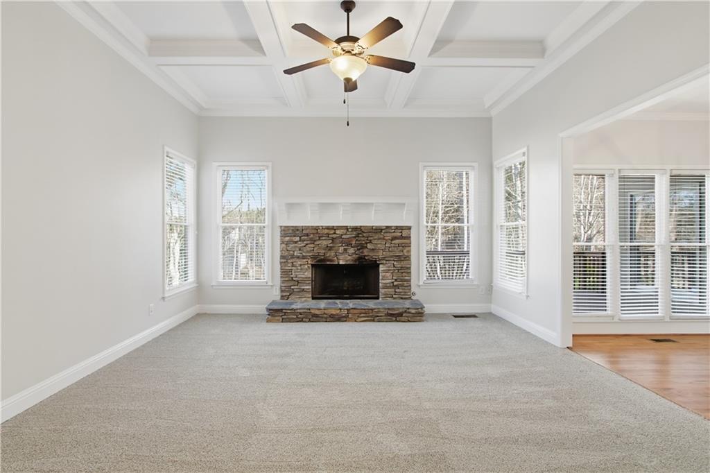 511 Highwater Pass Canton, GA 30114 - Photo 4 of 39 a view of a livingroom with a fireplace a ceiling fan and windows