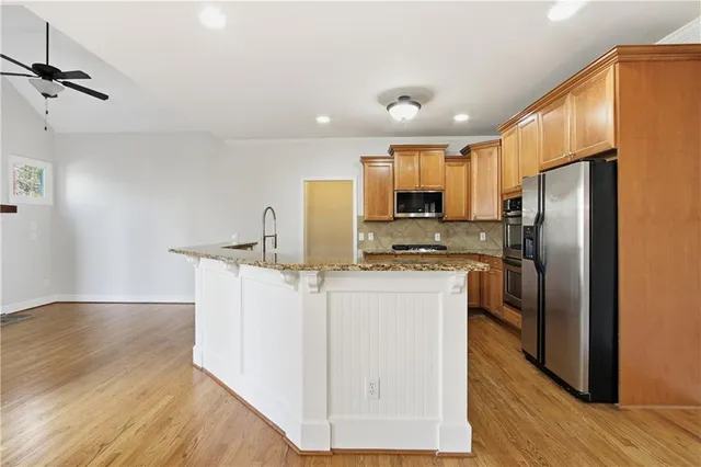 a kitchen with stainless steel appliances a refrigerator stove microwave and sink