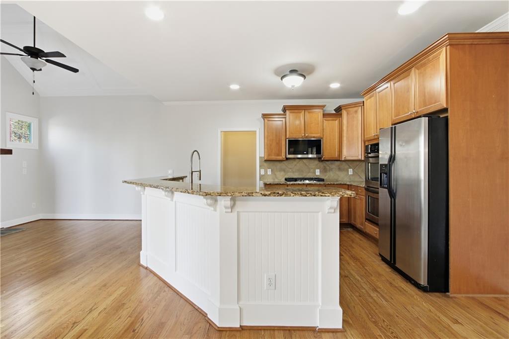 511 Highwater Pass Canton, GA 30114 - Photo 7 of 39 a kitchen with stainless steel appliances a refrigerator stove microwave and sink
