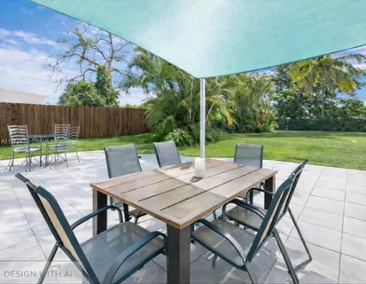 a view of a patio with a table chairs and a backyard