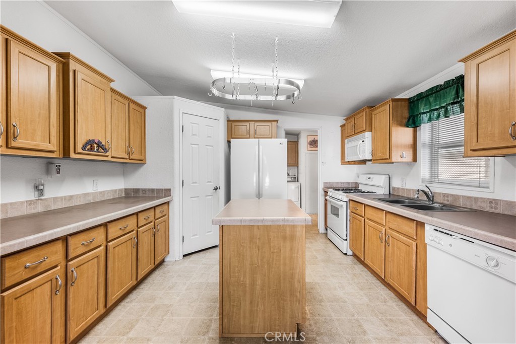 600 South Dennison, Unit 109 Tehachapi, CA 93561 - Photo 12 of 43 a large kitchen with stainless steel appliances granite countertop a sink and cabinets