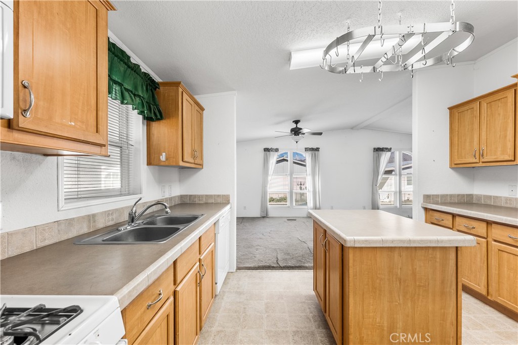 600 South Dennison, Unit 109 Tehachapi, CA 93561 - Photo 16 of 43 a kitchen with a sink a counter top space cabinets and stainless steel appliances