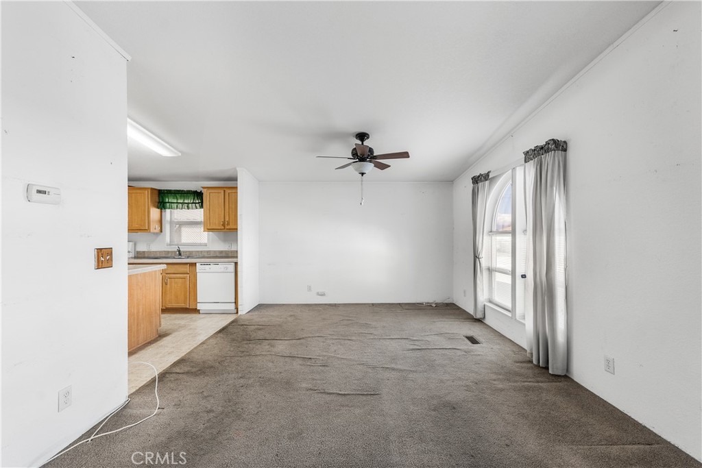 600 South Dennison, Unit 109 Tehachapi, CA 93561 - Photo 8 of 43 an empty room with a kitchen and a sink