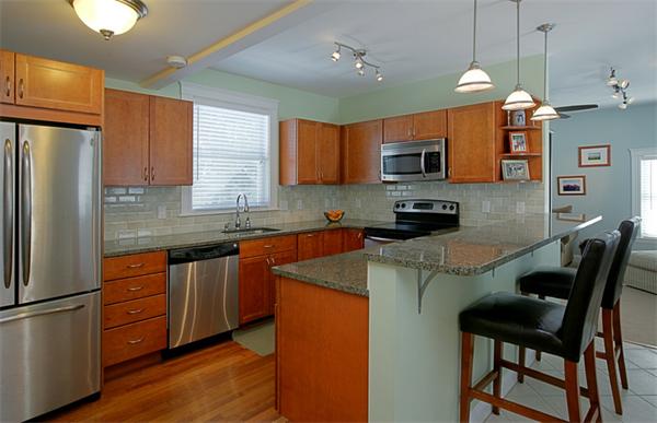 76 Fordham Road Newton, MA 02465 - Photo 1 of 1 a kitchen with stainless steel appliances granite countertop white cabinets a refrigerator a sink a stove a microwave and wooden floors
