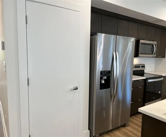 a metallic refrigerator freezer sitting in a kitchen