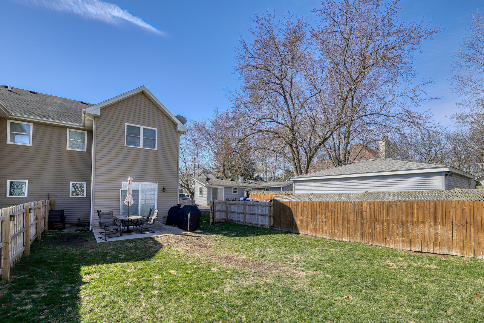 436 West Pierce Street Elburn, IL 60119 - Photo 21 of 28 a backyard of a house with fire pit and chairs