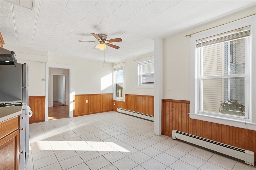 223 School Street, Unit 1 Lowell, MA 01854 - Photo 4 of 21 a bedroom with furniture and window