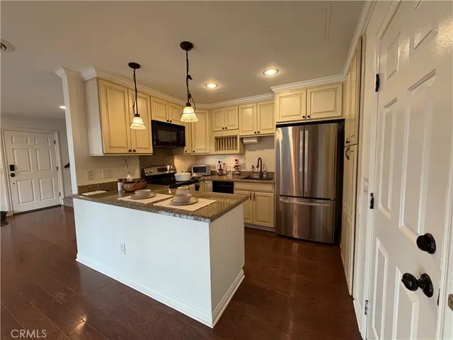 a kitchen that has a sink a stove and cabinets