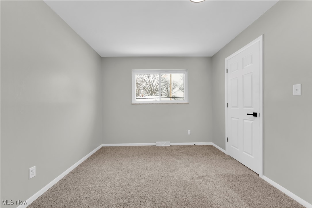 797 Babbitt Road, Unit 15 Euclid, OH 44123 - Photo 17 of 22 Empty room featuring baseboards and light carpet