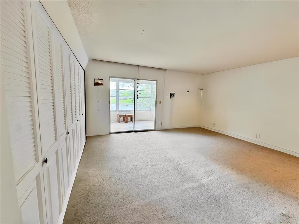 2029 Cambridge B, Unit 2029 Deerfield Beach, FL 33442 - Photo 14 of 36 a view of an empty room with a window