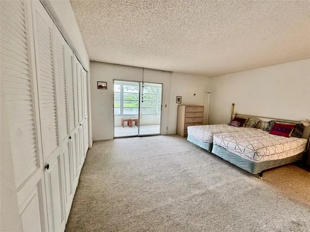 a bedroom with a large bed and a couch