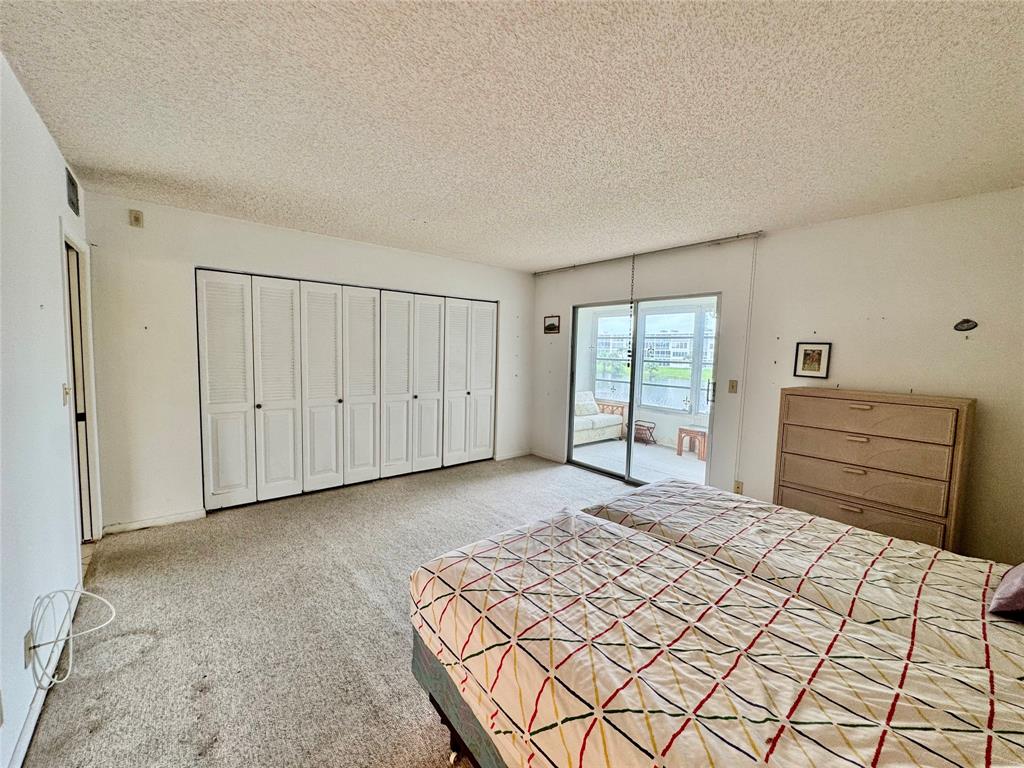 2029 Cambridge B, Unit 2029 Deerfield Beach, FL 33442 - Photo 17 of 36 a bedroom with a bed and a window