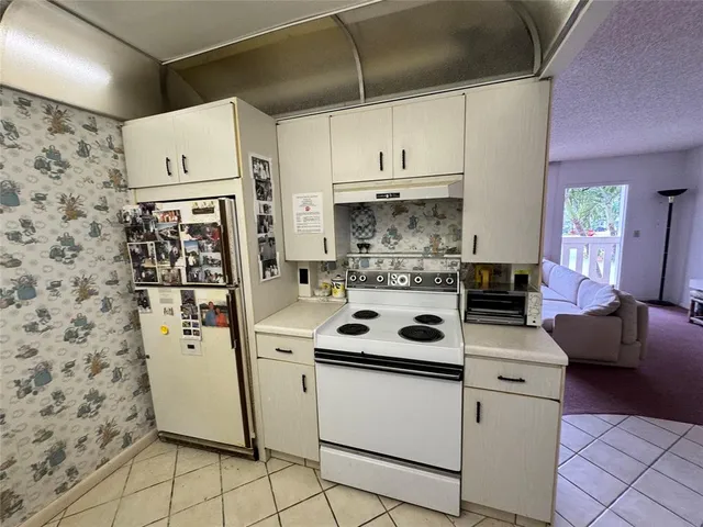a kitchen with stainless steel appliances a stove a sink and a refrigerator
