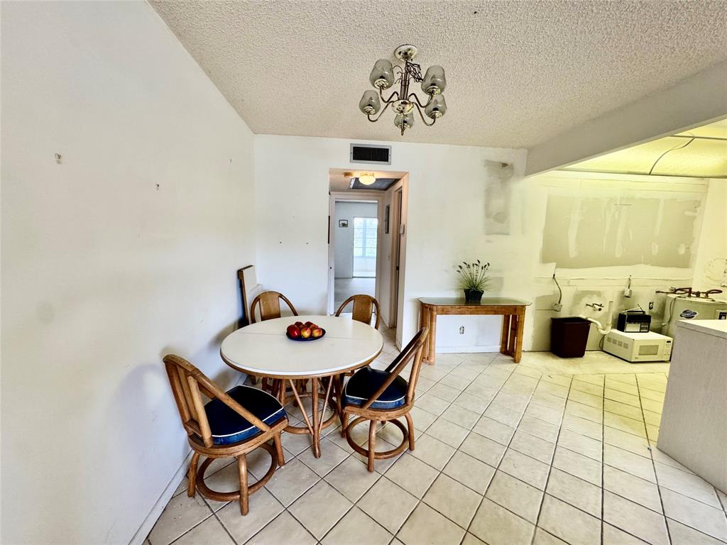 2029 Cambridge B, Unit 2029 Deerfield Beach, FL 33442 - Photo 7 of 36 a dining room with furniture and window
