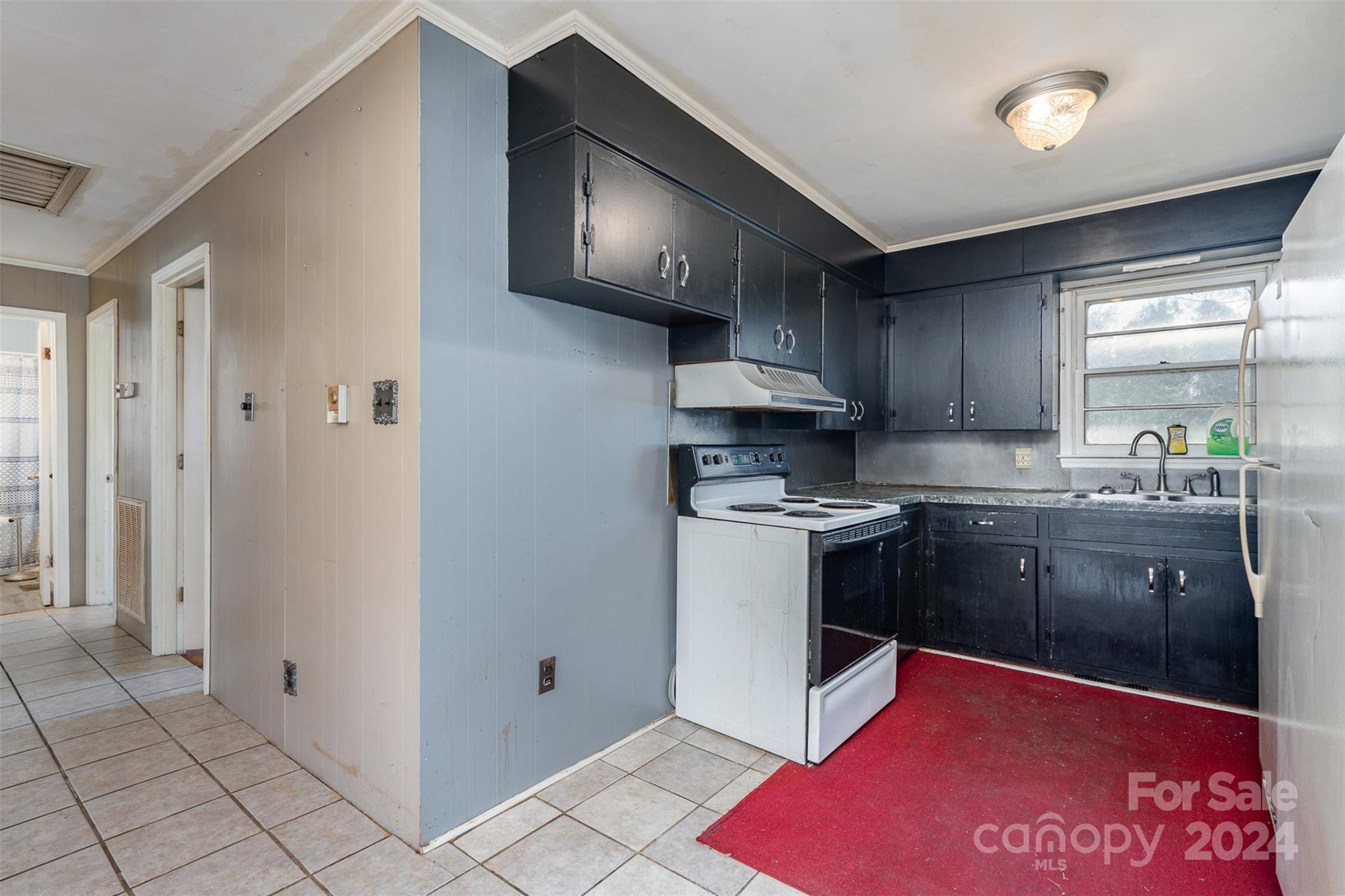 128 Paul Snipes Road Lancaster, SC 29720 - Photo 12 of 27 a kitchen with stainless steel appliances granite countertop a stove a sink and a refrigerator