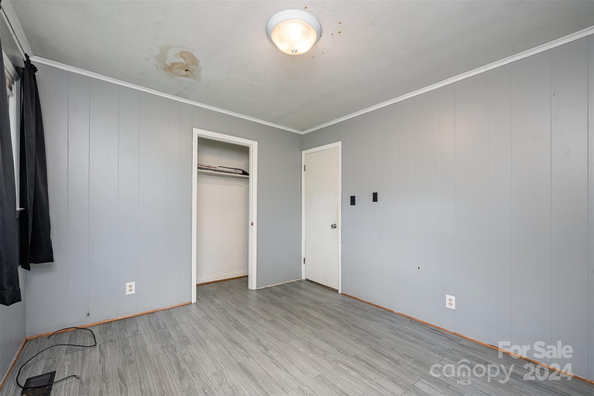 128 Paul Snipes Road Lancaster, SC 29720 - Photo 16 of 27 a view of an empty room with wooden floor and a window
