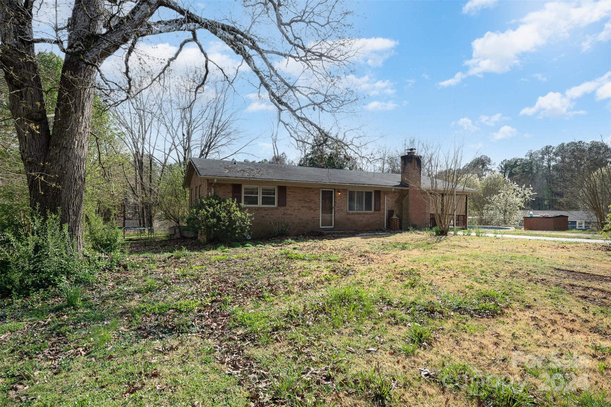 128 Paul Snipes Road Lancaster, SC 29720 - Photo 3 of 27 a backyard of a house with table and chairs under an umbrella