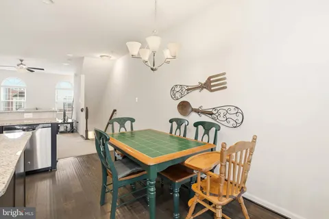 a dining room with furniture and wooden floor