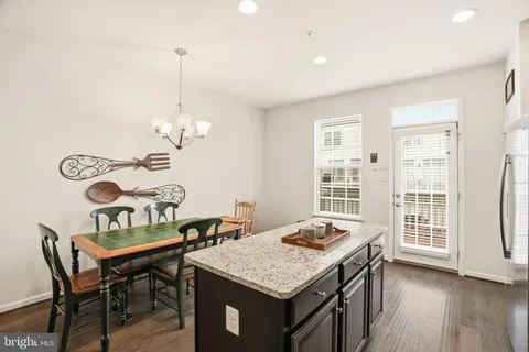 a view of a room that has a table and chairs in it