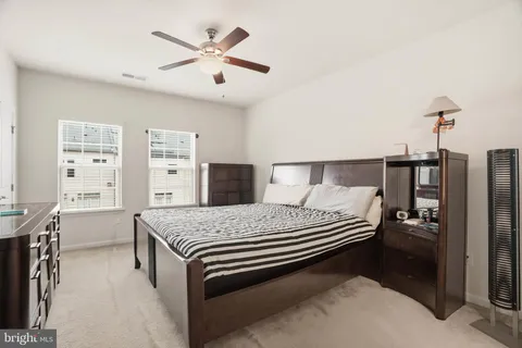 a spacious bedroom with a bed and a chandelier