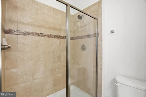 a bathroom with a shower and a toilet