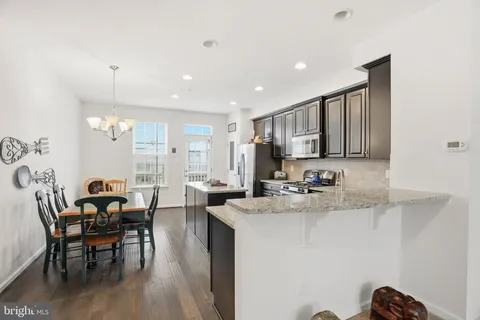a kitchen with counter top space a sink appliances and cabinets