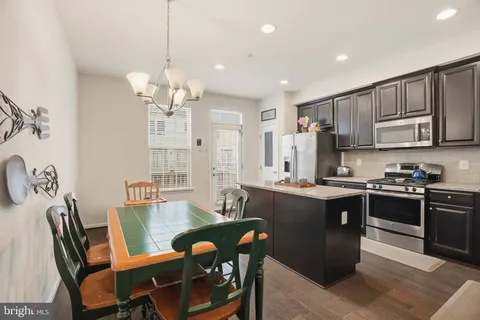 a view of kitchen with sink dining table and chairs