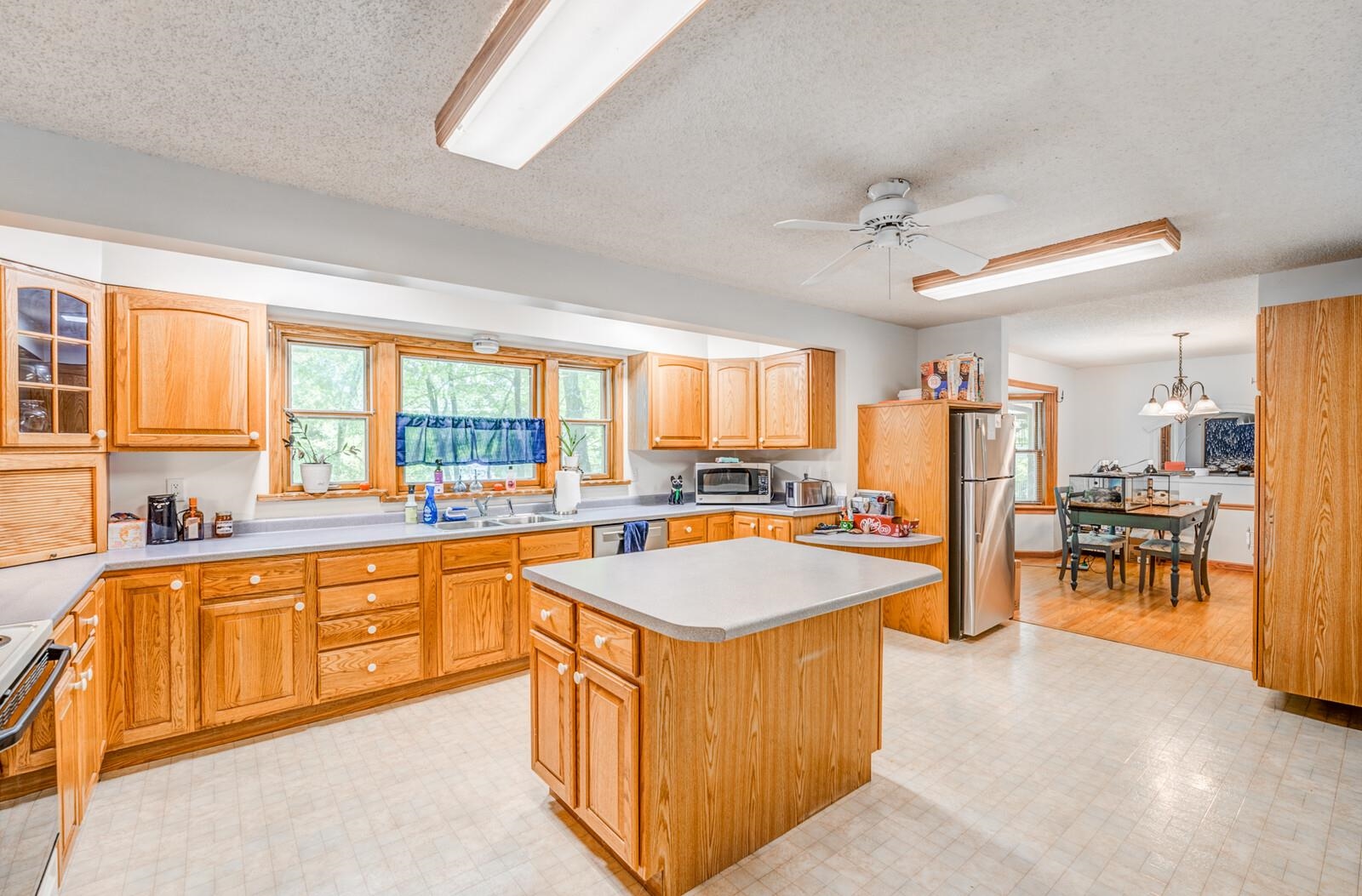 8651 Baylor Road Bartlett, TN 38002 - Photo 6 of 29 a large kitchen with kitchen island a large counter top space appliances and a center island