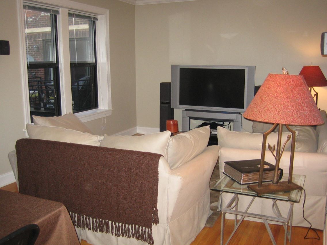 Undisclosed Address Chicago, IL 60613 - Photo 3 of 6 a living room with furniture and a flat screen tv