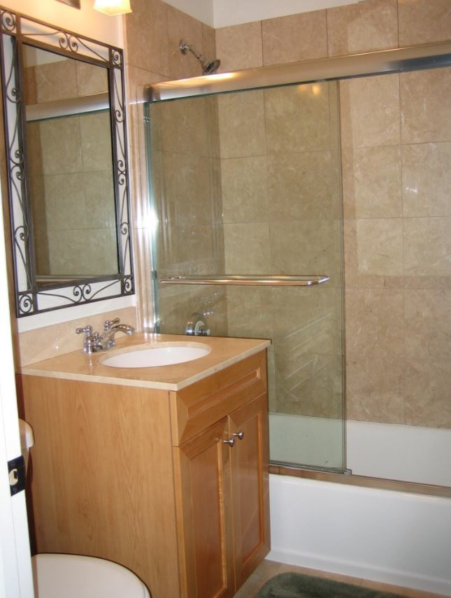 Undisclosed Address Chicago, IL 60613 - Photo 6 of 6 a bathroom with a sink and a mirror