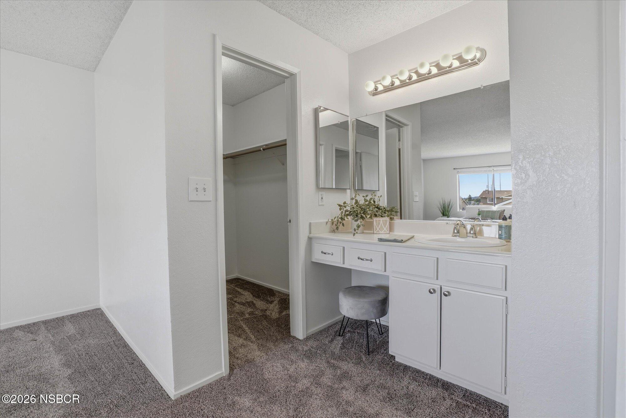 1192 Sumner Place, Unit D Santa Maria, CA 93455 - Photo 11 of 18 a bathroom with a double vanity sink and a mirror