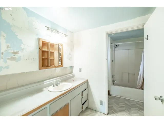 a bathroom with a sink a mirror and a shower